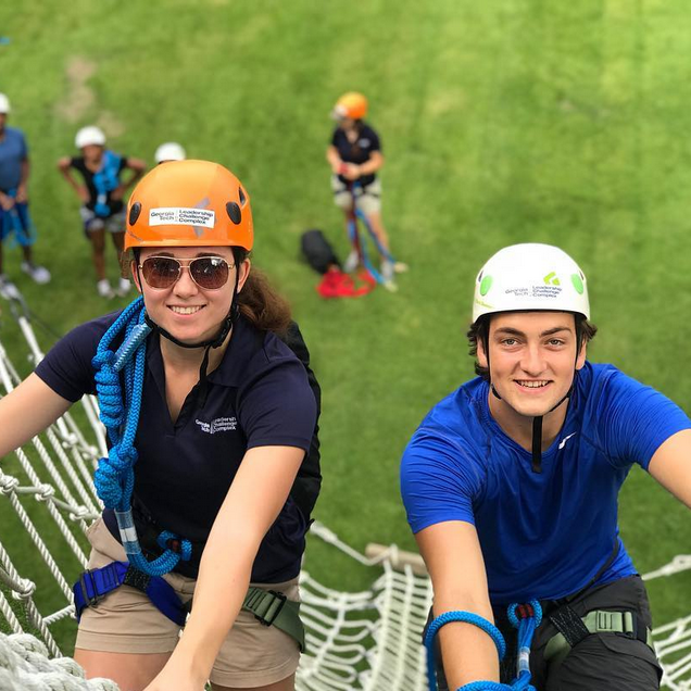Two GT students climbing the ropes at the LCC.