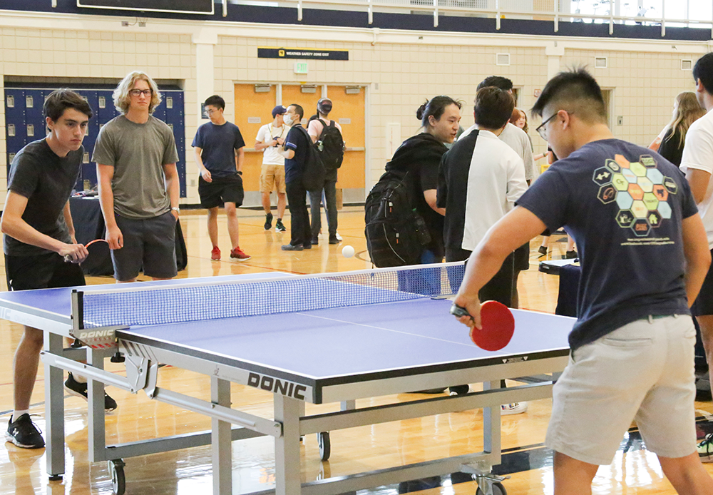 Young men playing table tennis during the 2022 RecFest.